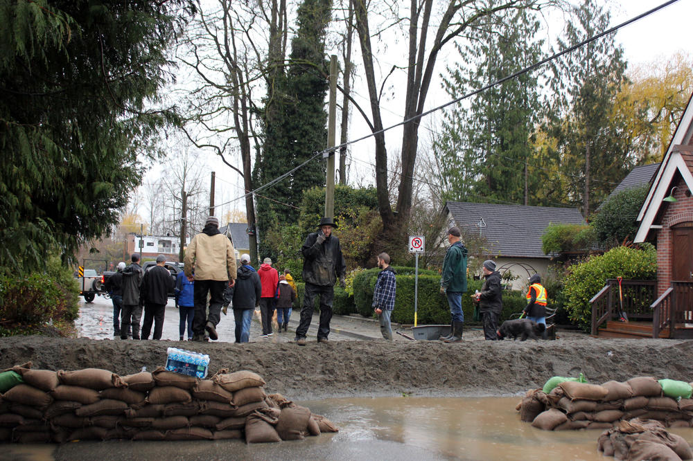 Residents and volunteers created a barrier of sandbags to protect homes in Abbotsford threatened by further flooding, on Nov. 28.