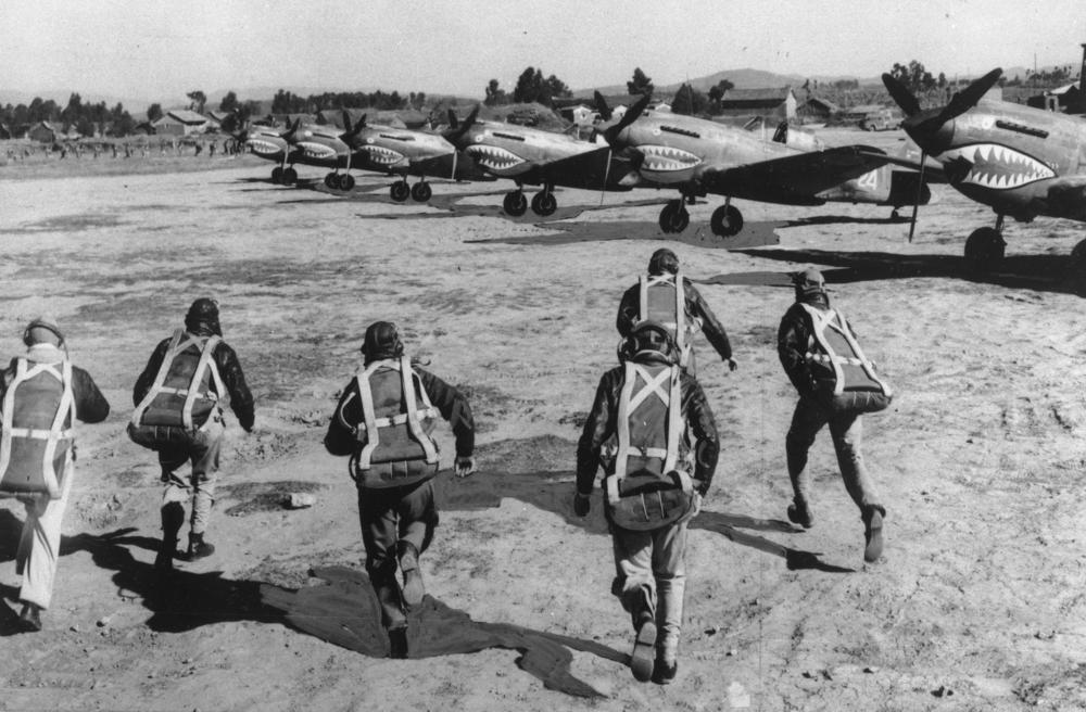 Pilots of the Flying Tigers run for their Curtiss P-40 fighters as an air raid warning sounds at an unknown airbase in China on Nov. 2, 1943. The AVG was integrated into the U.S. military in 1942 as part of the 23d Fighter Group, which continued to use the name Flying Tigers.