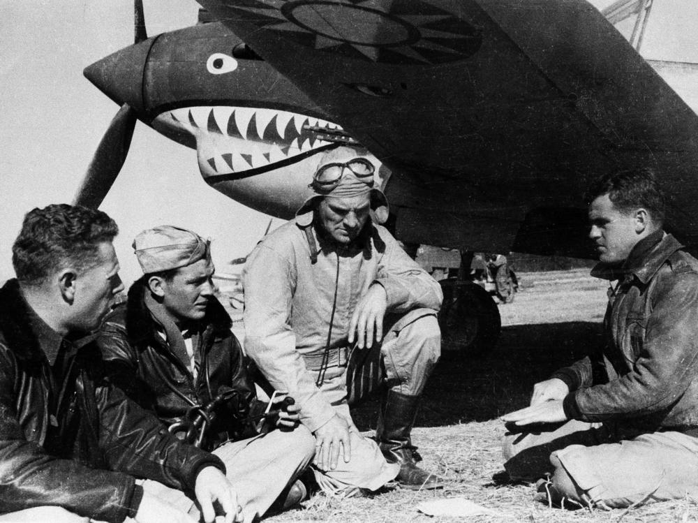 Pilots from the American Volunteer Group sit in front of a P-40 airplane in Kunming, China, on March 27, 1942. The group was notable for its unusual mission: Its members were mercenaries hired by China to fight against Japan.