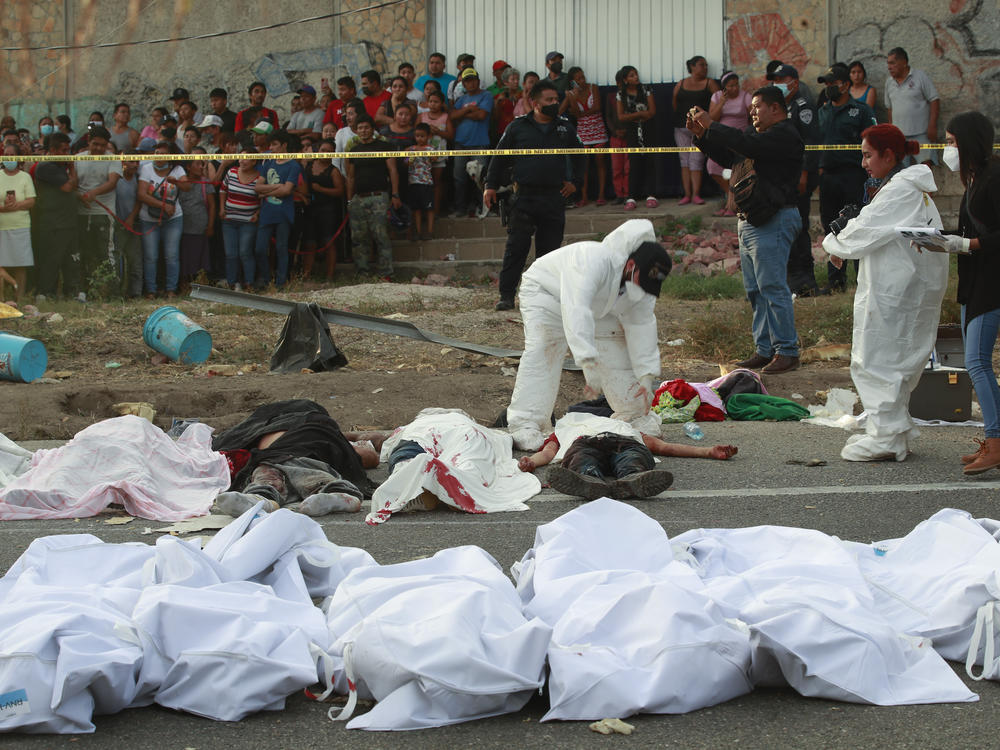 Bodies in bodybags are placed on the side of the road after an accident in Tuxtla Gutierrez, Chiapas state, Mexico, Dec. 9, 2021.