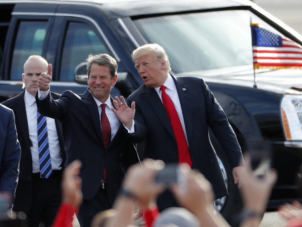 Georgia Republican Gov. Brian Kemp, at the time a candidate for governor, walks with then-President Trump as Trump arrives for a rally in Macon, Ga. on Nov. 4, 2018, just days before the election. Sour on Kemp, Trump is now backing former U.S. Senator David Perdue for the 2022 GOP primary for governor.