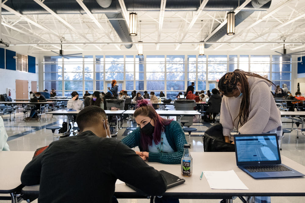 Sierra Hannipole helps Dreshon Robinson with biology during the learning hub. The hub is open to all students Monday through Thursday after school. Students can get help with schoolwork or see a counselor. There's also free food.
