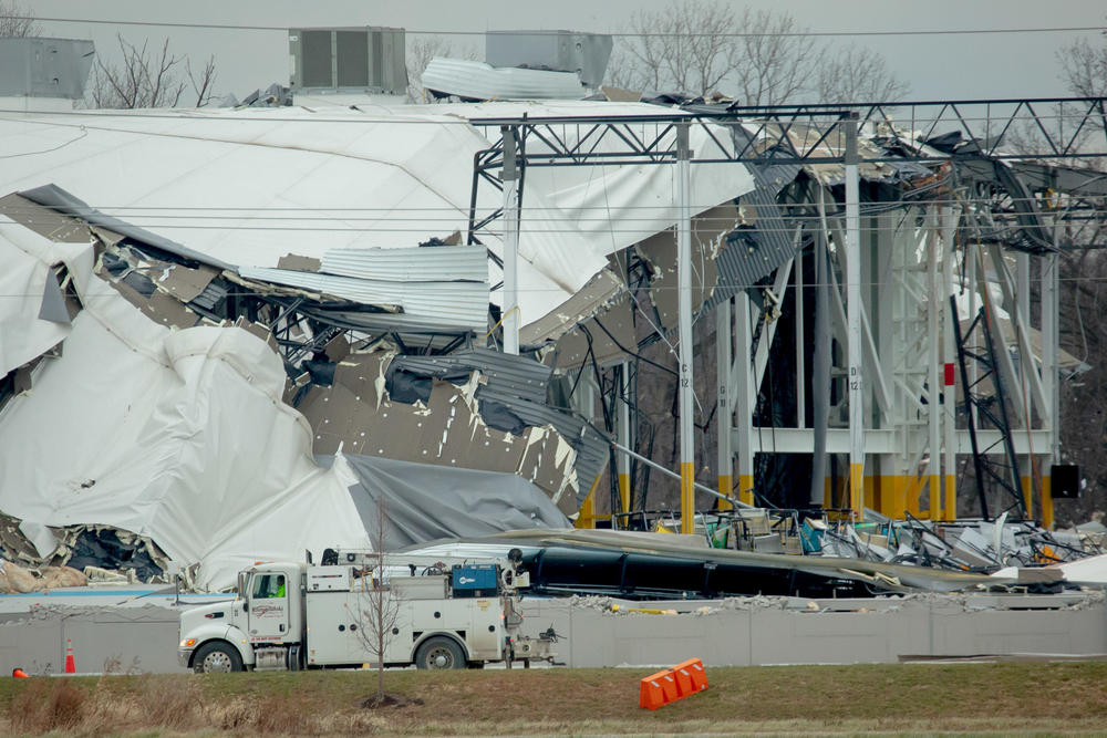 <strong>Sat., Dec. 11:</strong> Workers attempt to clear debris as part of a search and rescue operation on Saturday at an Amazon Distribution Hub in Edwardsville, Ill.