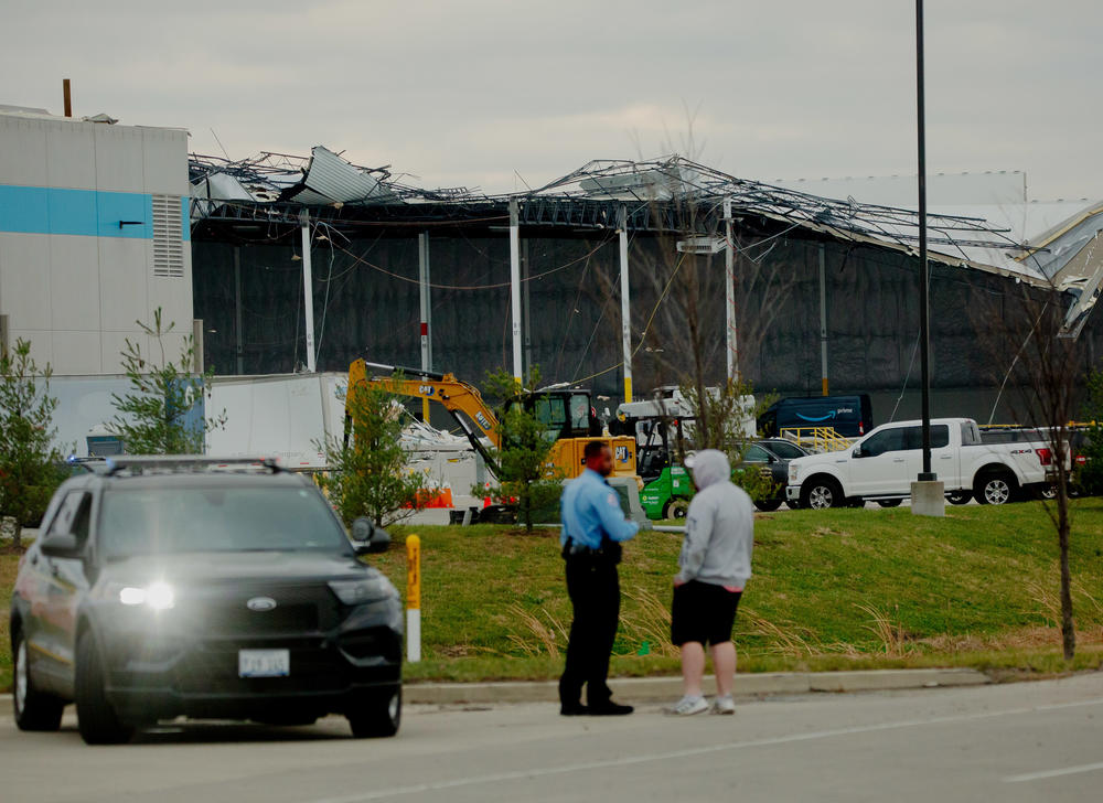 <strong>Sat., Dec. 11:</strong> Workers attempt to clear debris as part of a search and rescue operation on Saturday at an Amazon Distribution Hub in Edwardsville, Ill.