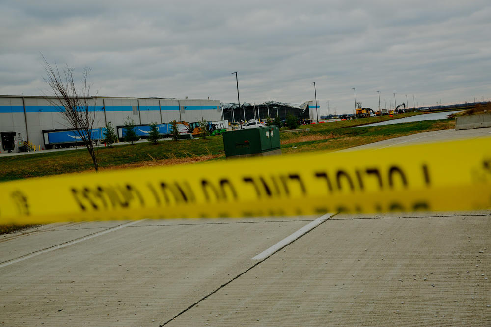 <strong>Sat., Dec. 11: </strong>Workers attempt to clear debris as part of a search and rescue operation at an Amazon Distribution Hub in Edwardsville, Ill.