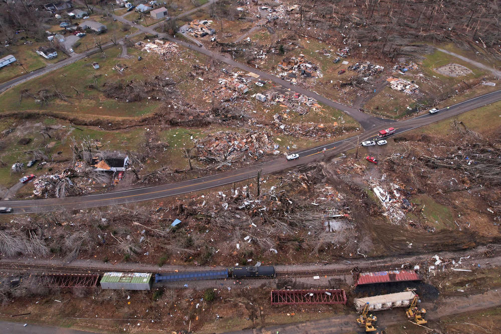 <strong>Sat., Dec. 11: </strong>A derailed train is seen amid damage and debris.