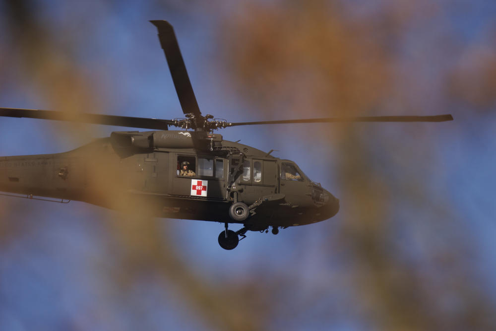 <strong>Sat., Dec. 11: </strong>A Kentucky National Guard helicopter surveys the tornado damage near Mayfield Consumer Products on Saturday in Mayfield, Ky.
