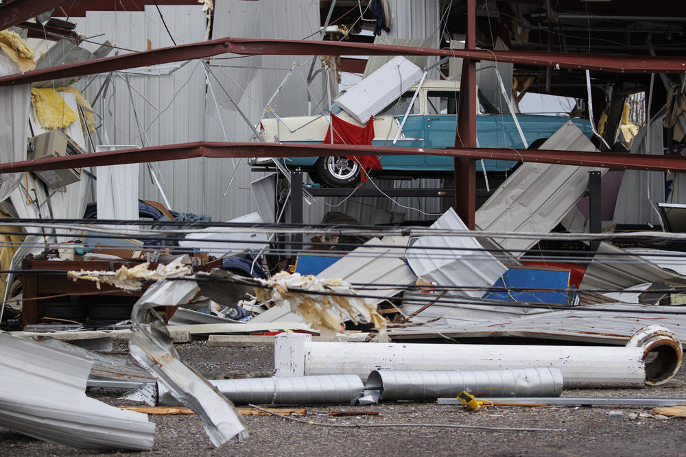 <strong>Sat., Dec. 11: </strong>A classic Chevrolet sits amidst a tornado destroyed building on Saturday in Mayfield, Ky.