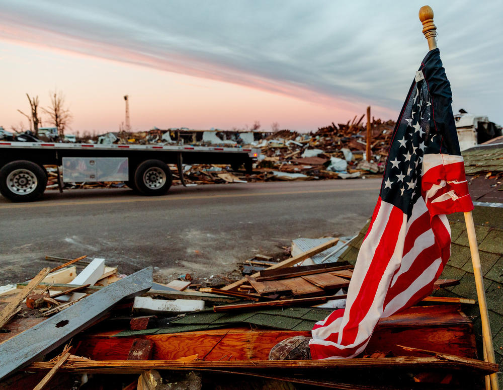 <strong>Sat., Dec. 11:</strong> An American flag is propped against debris in Mayfield, Kentucky.