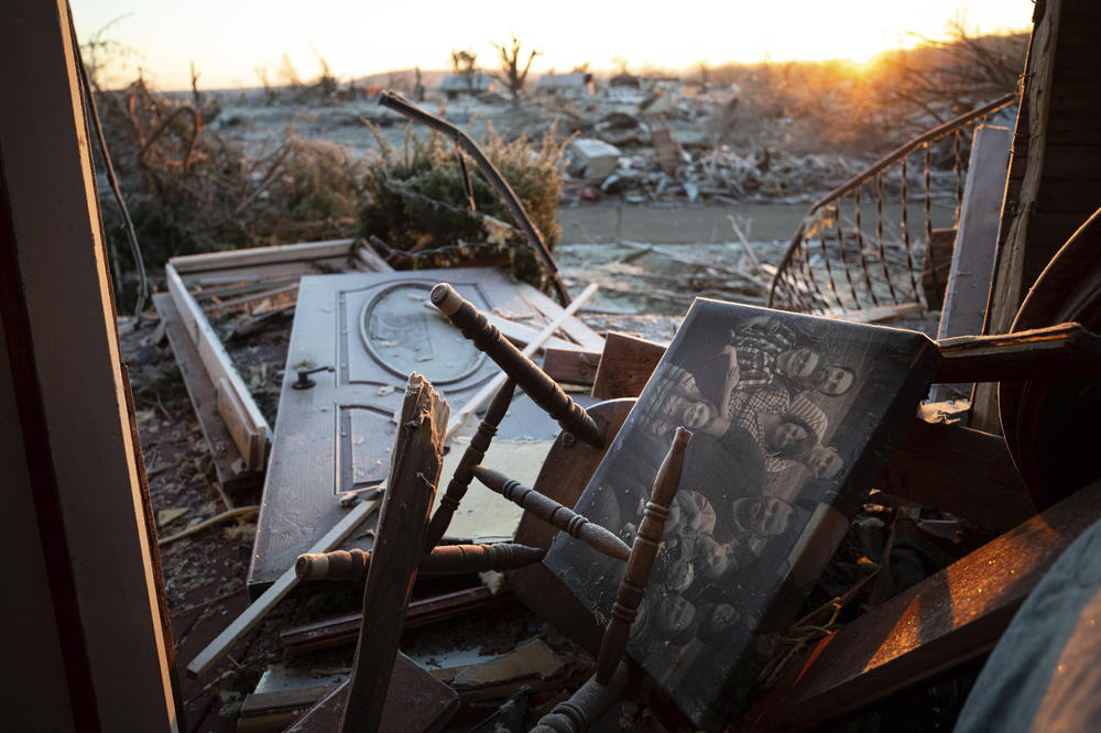 <strong>Sun., Dec. 12: </strong>A family photo lays among the debris inside of a house after a tornado in Dawson Springs, Ky.