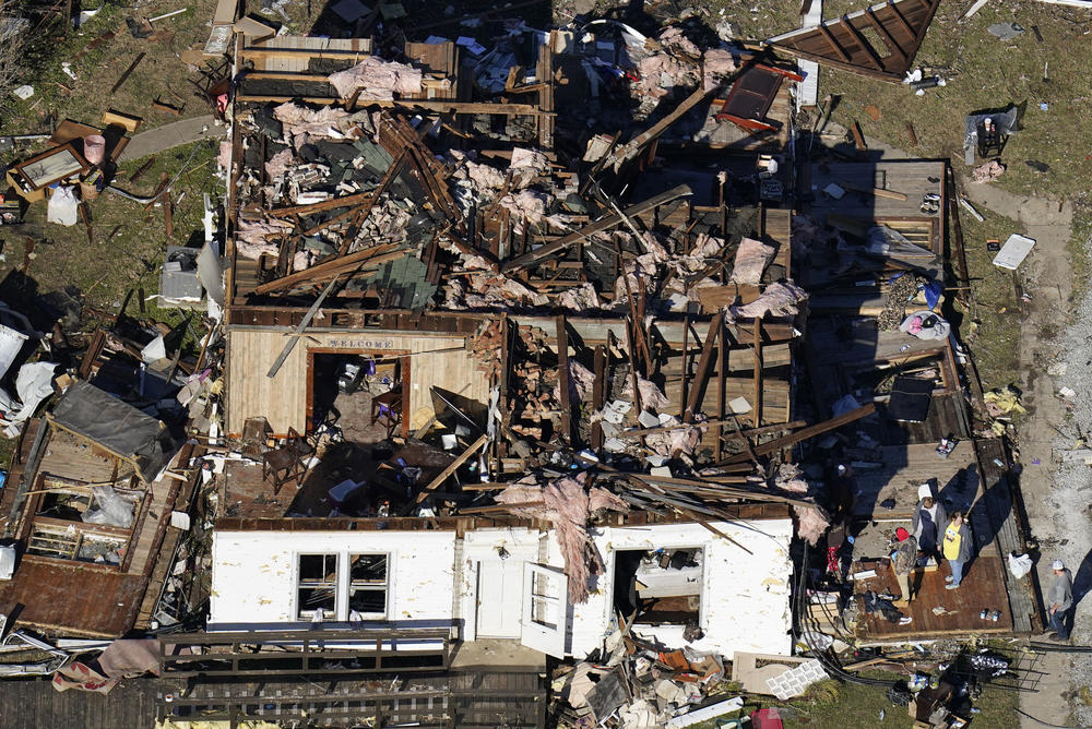 <strong>Sun., Dec. 12: </strong>In this aerial photo, people stand on the porch of a destroyed home in the aftermath of tornadoes that tore through the region, in Dresden, Tenn.