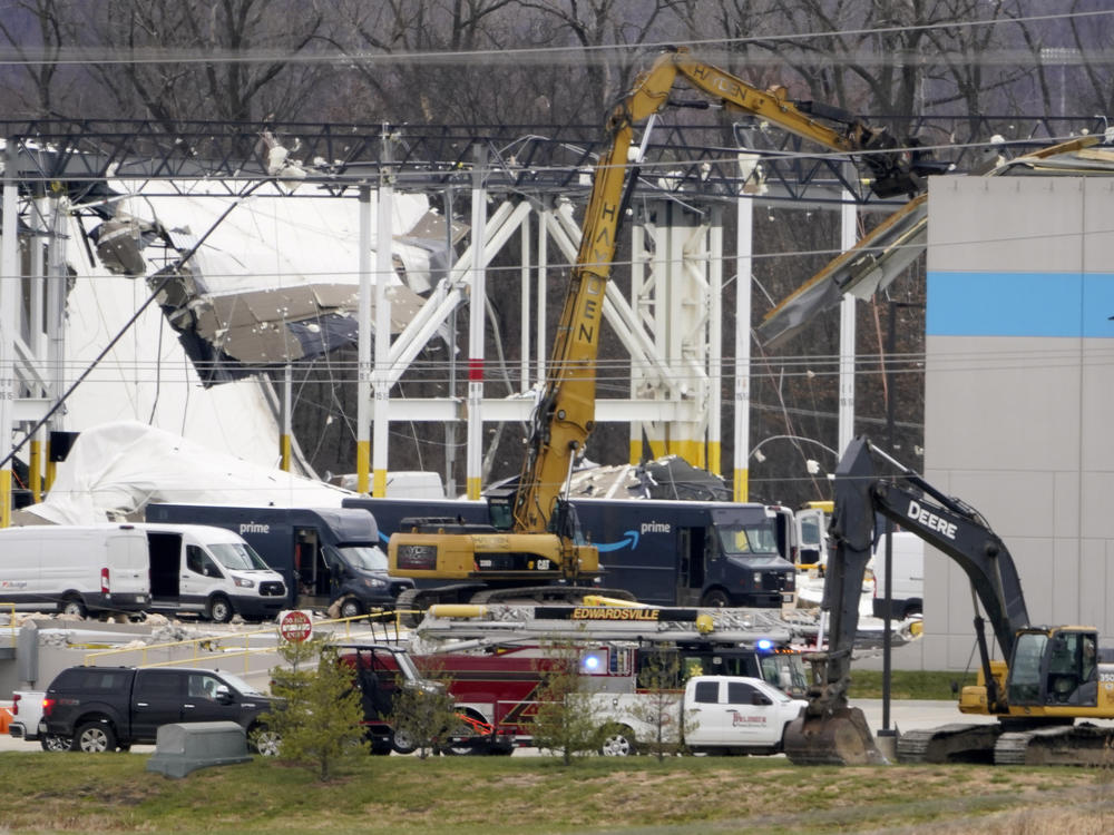 A heavily damaged Amazon fulfillment center is seen Saturday in Edwardsville, Ill.