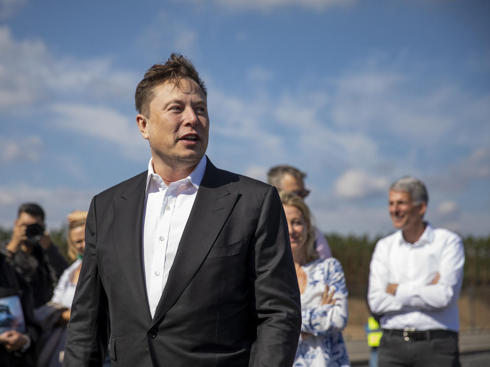 Tesla head Elon Musk talks to the press as he arrives to to have a look at the construction site of the new Tesla Gigafactory near Berlin last year.