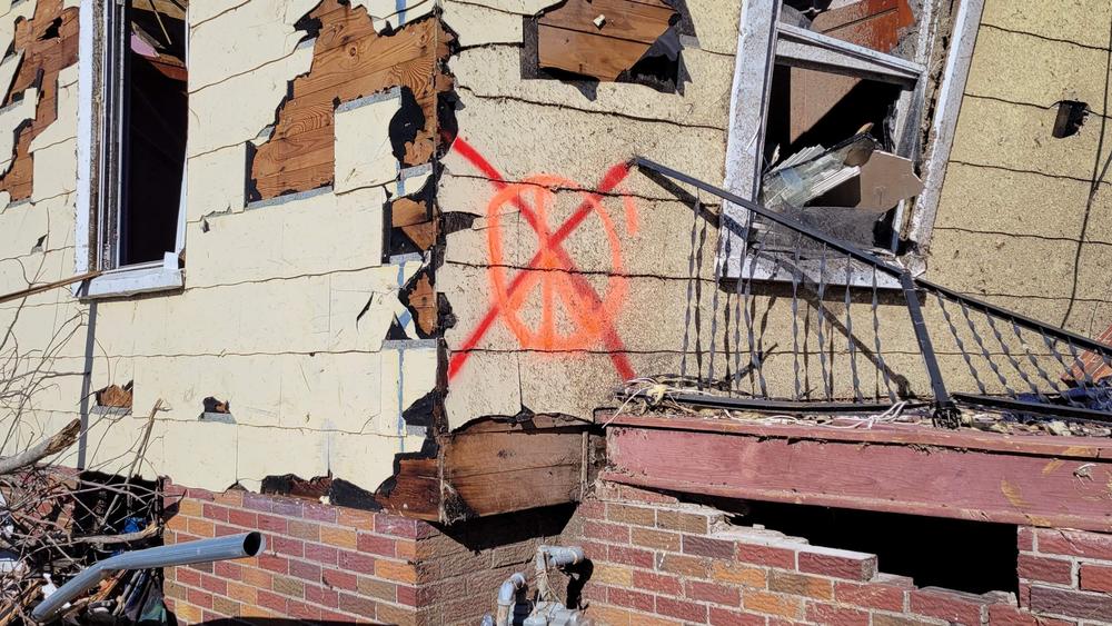 The ruins of homes are marked with symbols after they're searched and cleared of any remains or hazards.