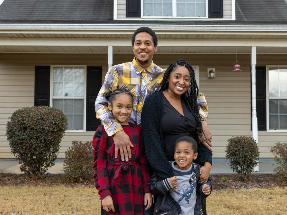 Nicole Howson and her family stand in front of their new home in Griffin, Ga. Clockwise: Nicole Howson, Israel Epps, Talysa Epps and Latroun Epps.