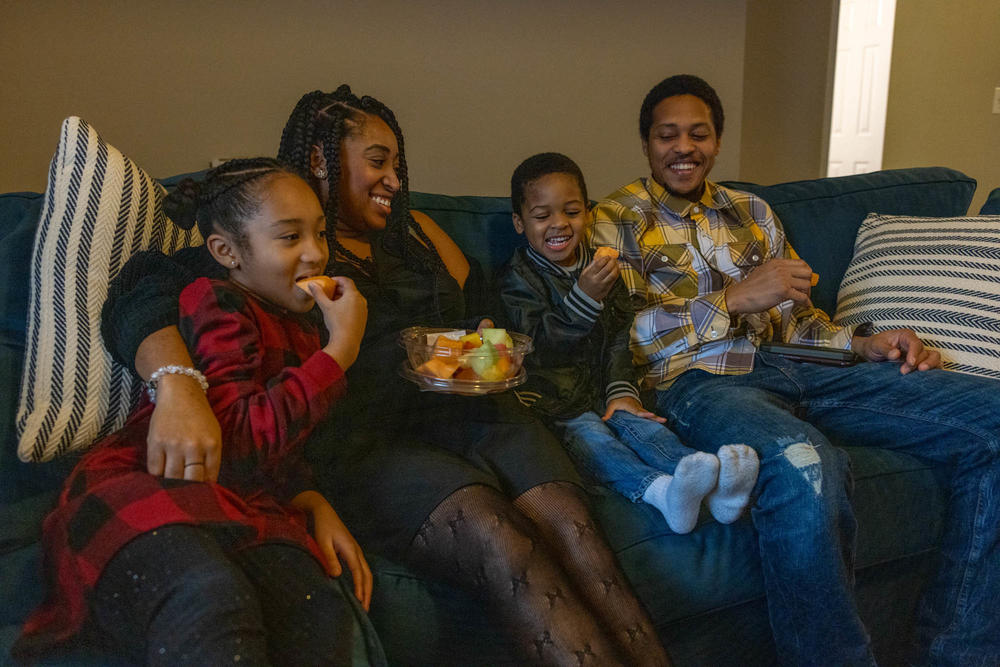 Nicole Howson spends time in her new living room with her family.