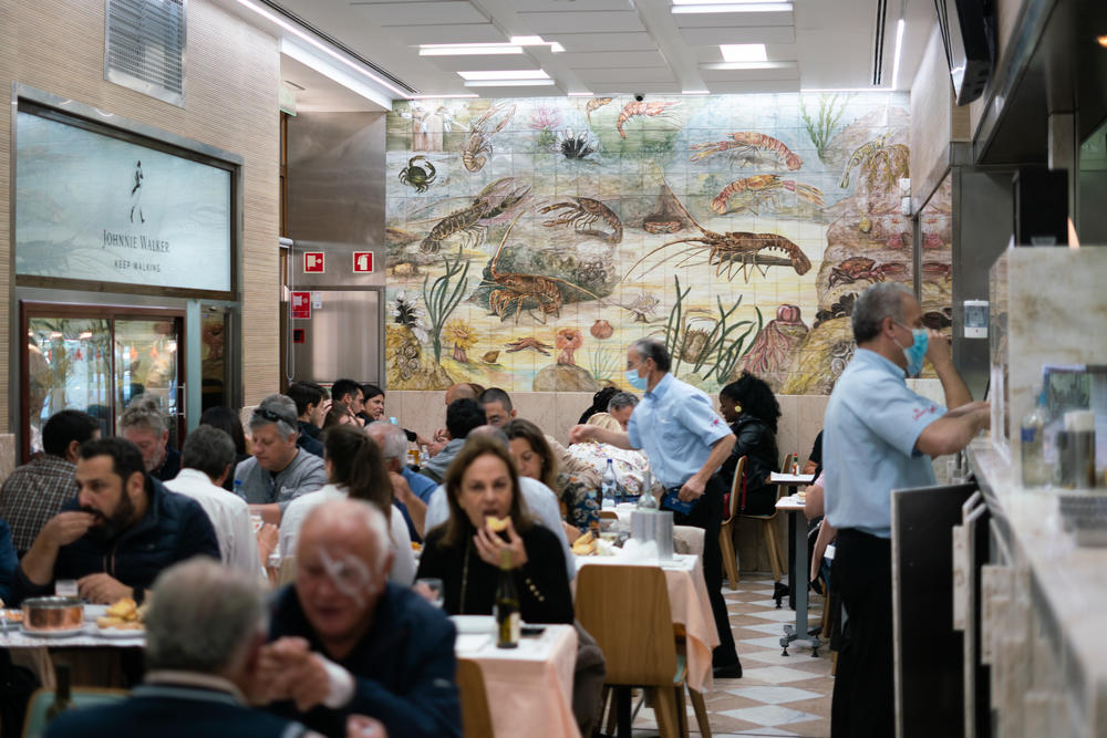 A crowded lunch scene at Cervejaria Ramiro, a popular seafood restaurant in Lisbon, Portugal.