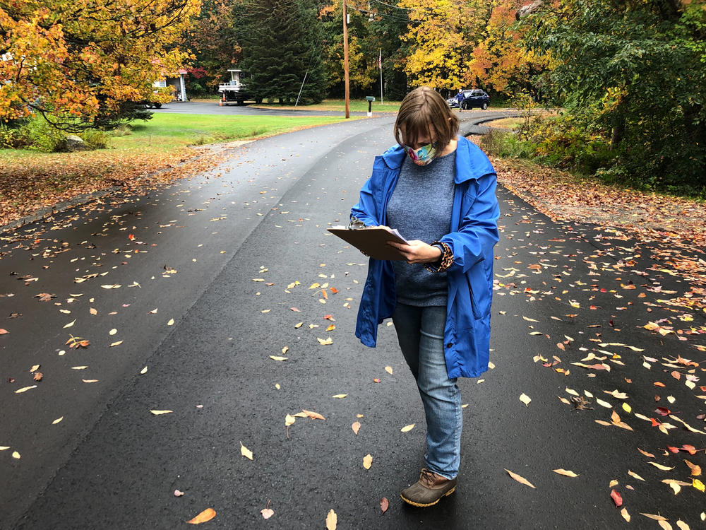 Planned Parenthood volunteer Sarah Mahoney checks a list of addresses in Windham, Maine to see which door to knock on next.