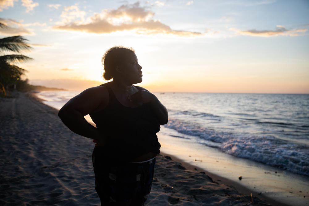 With the sun setting off the coast of northern Honduras, Ella Guity watches her daughters, Jirian and Eleny, swim in the warm Caribbean waters of the village of Rio Esteban, home to a group with African and Indigenous roots known as the Garifuna. Ella had left years earlier for life in the big city, but the pandemic led her back home.