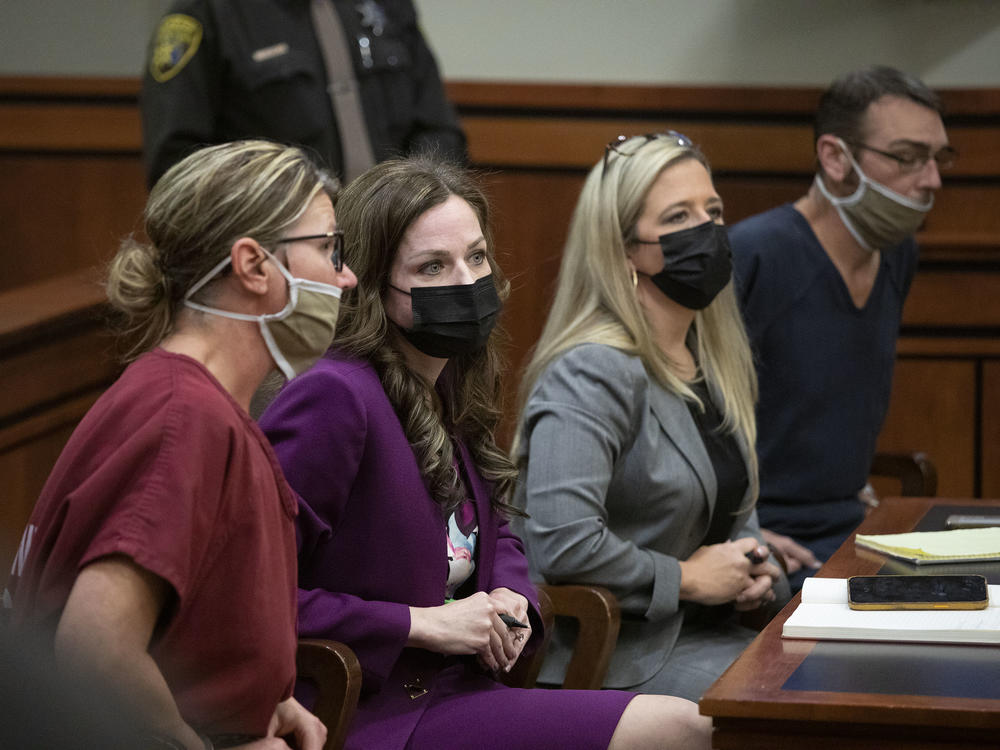 James Crumbley, far right, and Jennifer Crumbley, far left, sit with their attorneys in district court in Rochester Hills, Mich., on Tuesday for a probable cause conference in the case of the Oxford High School mass shooting.