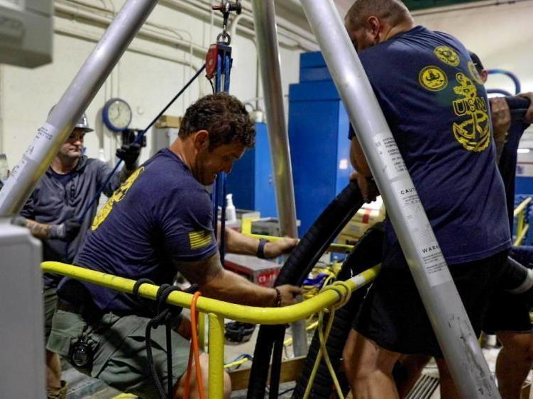 In this Dec. 11, 2021 photo provided by the U.S. Navy, Mobile Diving Salvage Unit One performs inspection and sampling of a water well near Pearl Harbor, Hawaii.