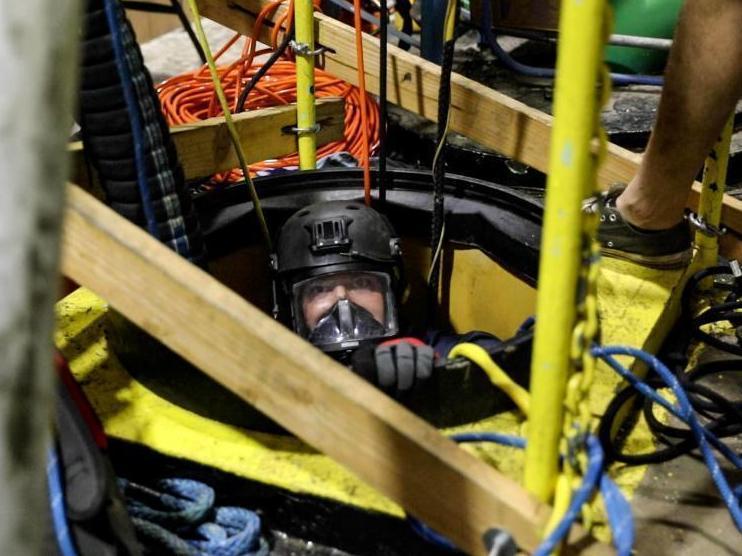This Dec. 11, 2021 photo, provided by the U.S. Navy, shows a diving salvage unit at work in a contaminated water well near Pearl Harbor, Hawaii.