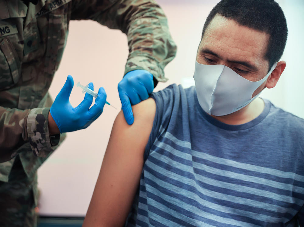 Maryland National Guard Spc. James Truong administers a Moderna COVID-19 vaccine on May 21 in Wheaton, Maryland. People vaccinated with the Moderna vaccine likely need a booster to keep up their protection against the new omicron variant of the coronavirus.