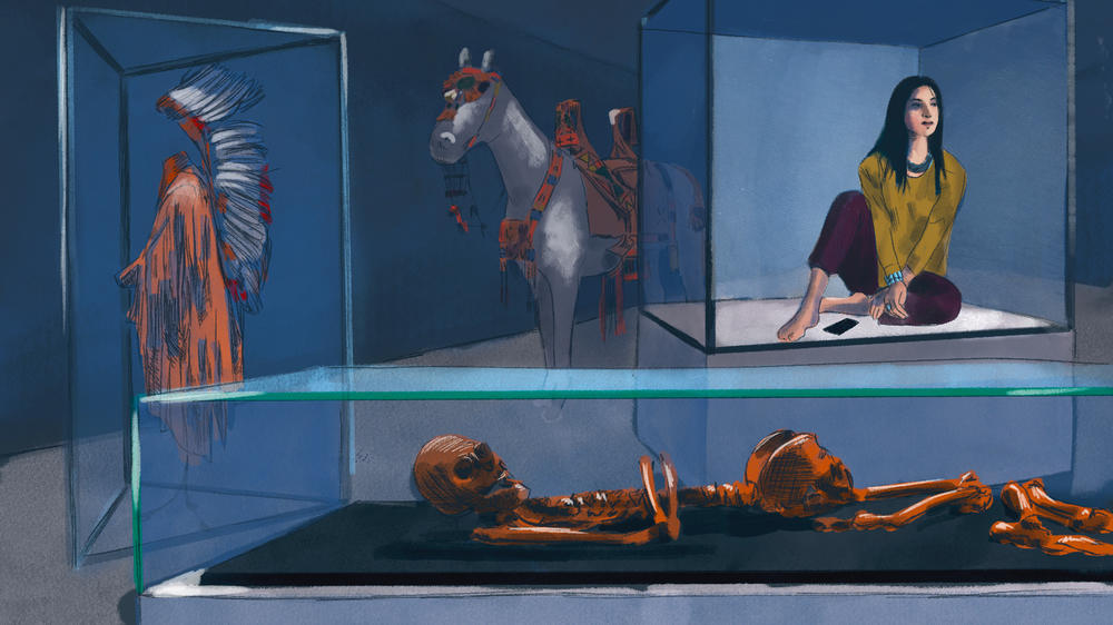 A young Native American woman sits in a museum display case alongside artifacts and human remains.