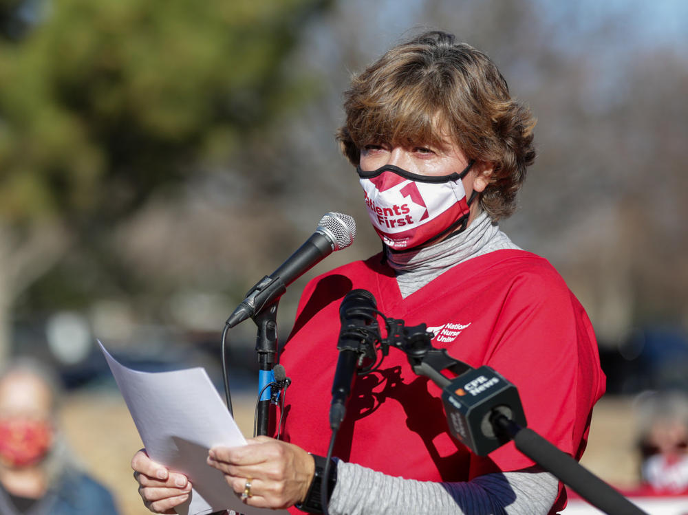 Longmont United Hospital nurse Kris Kloster speaks to other nurses and supporters December 2, 2021, outside the hospital. They say the hospital is severely understaffed, their workload is unsustainable, and the hospital is trying to block them from forming a union.