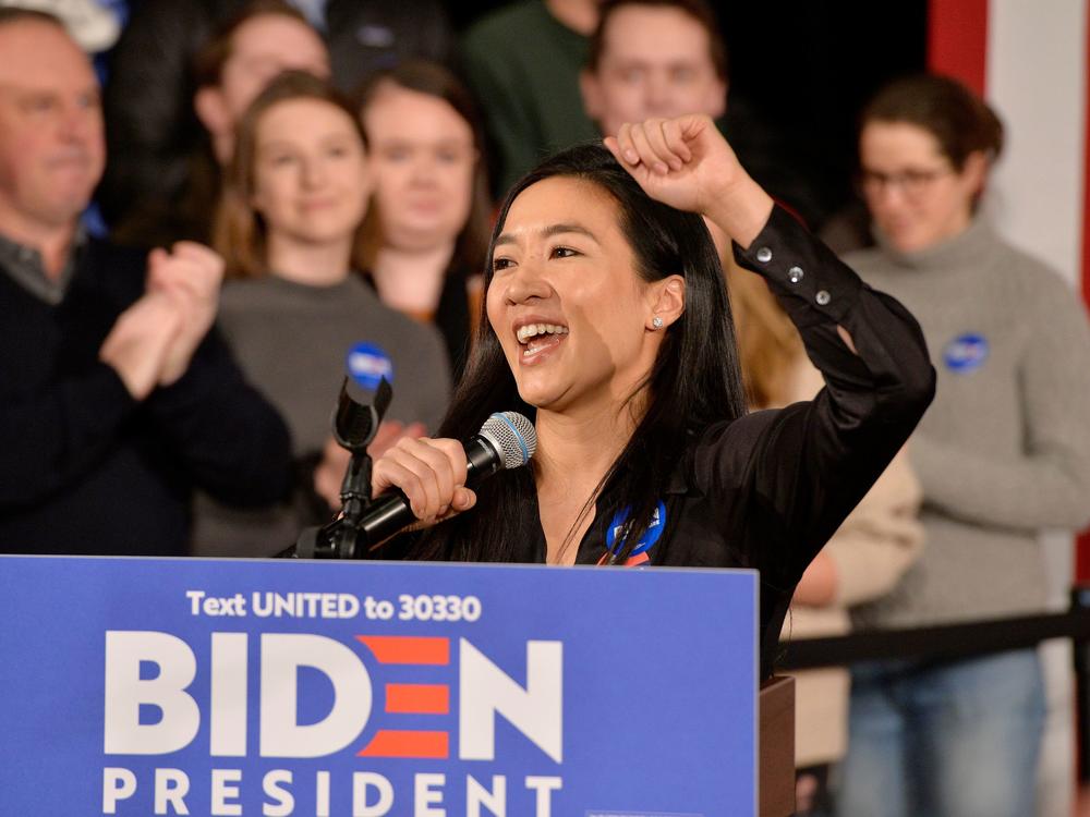 Former Olympian Michelle Kwan speaks before then-candidate Joe Biden at a rally in Manchester, N.H., on Feb. 8, 2020. On Wednesday President Biden said he'll nominate Kwan for ambassador to Belize.