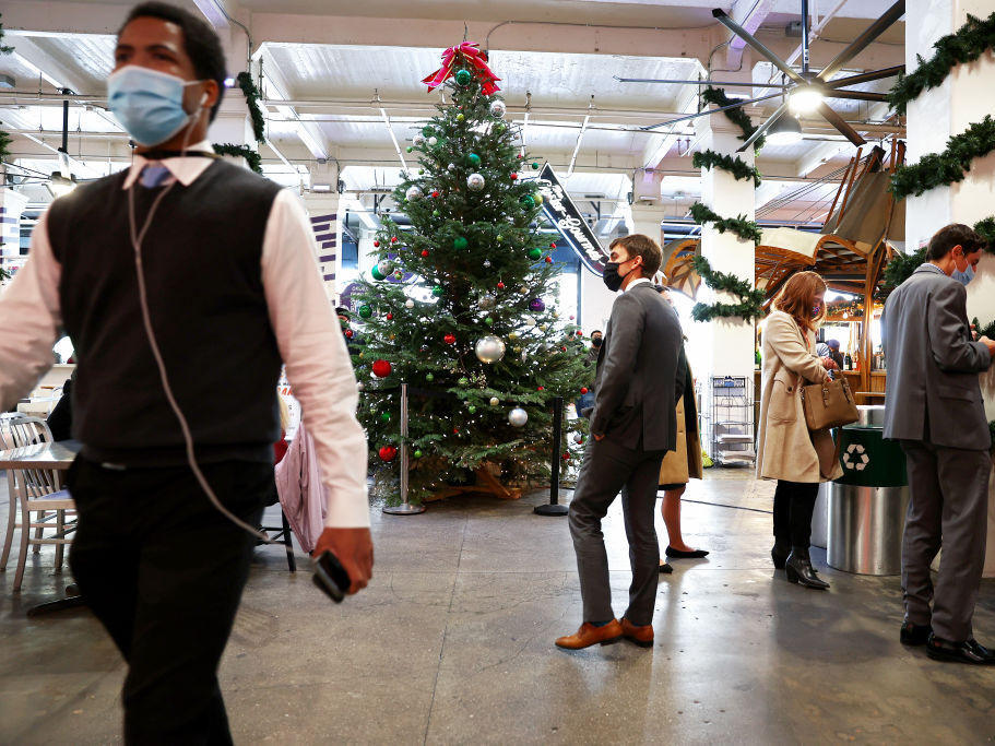 People wear face coverings inside Grand Central Market on Wednesday in Los Angeles. California residents, regardless of COVID-19 vaccination status, are required to wear face masks in all indoor public settings beginning Wednesday.