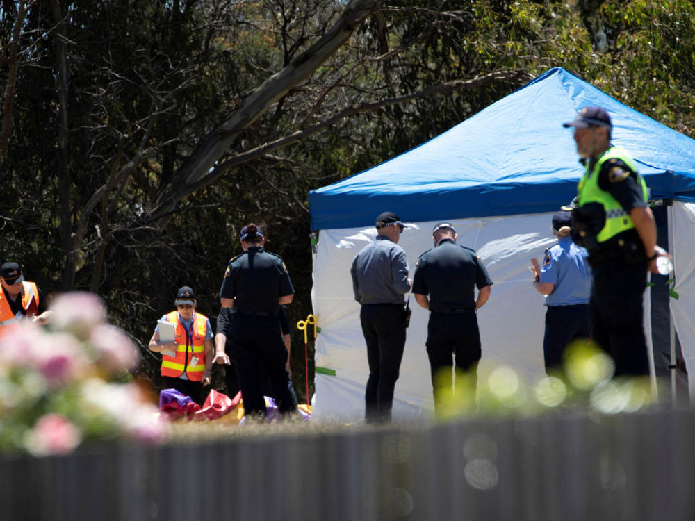 Worksafe Tasmania officers inspect a bouncy castle at Hillcrest Primary School in Devonport, Tasmania, on Thursday. A strong gust of wind lifted the castle some 30 feet into the air at an event celebrating the end of the school year.