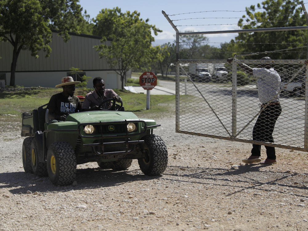 Workers ride out of the gate of the Christian Aid Ministries headquarters in Titanyen, north of Port-au-Prince, Haiti, on Dec. 6.
