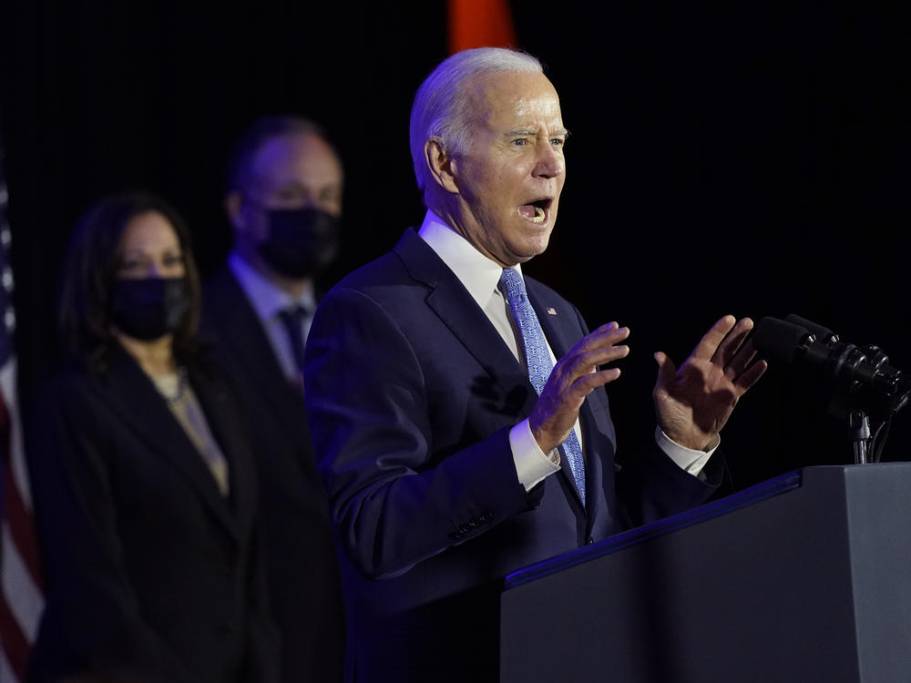 President Biden speaks at a Democratic National Committee holiday party on Tuesday in Washington, as Vice President Kamala Harris and second gentleman Doug Emhoff listen. The Biden Administration announced its action plan this week to replace the country's lead pipes, which impacts up to 10 million households.