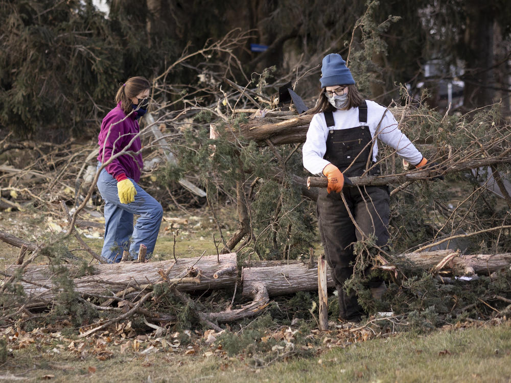 Residents clear fallen trees Thursday, after a strong storm swept through Hartland, Minn. A powerful storm system swept across the Great Plains and Midwest, bringing hurricane-force wind gusts and spawning reported tornadoes in Nebraska, Iowa and Minnesota.