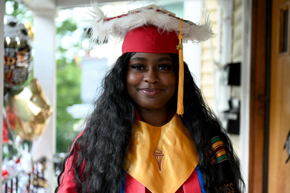 Anne Laurie Pierre, a recent graduate of Everett High School, stands outside of her home in Somerville, Mass., on June 15. She juggled a job and caring for younger siblings with remote classes. <a href=