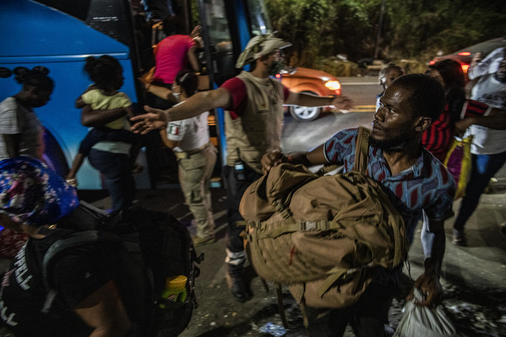Haitian migrants boarding INM northbound buses in Tapachula.