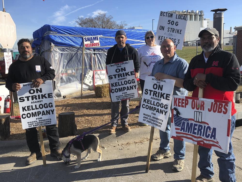 Striking Kellogg's workers stand outside the Omaha, Neb., cereal plant on, Dec. 2. The company reached a new tentative agreement on Thursday, with its 1,400 cereal plant workers that could bring an end to the strike that began Oct. 5.
