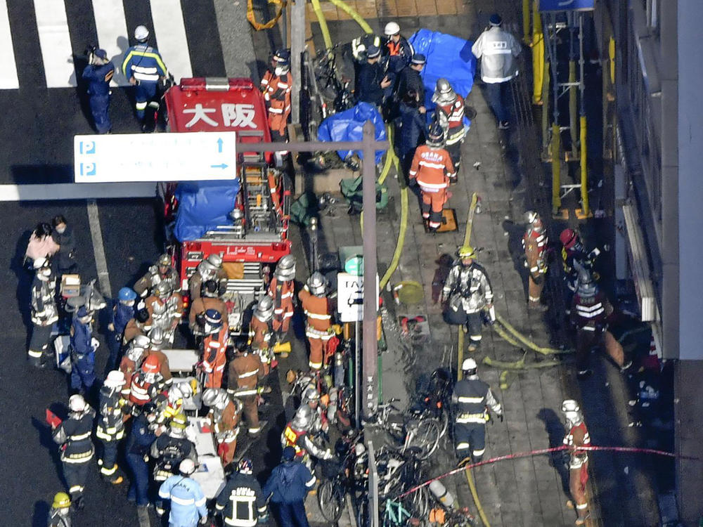 Policemen and firefighters gather near the building in Osaka.