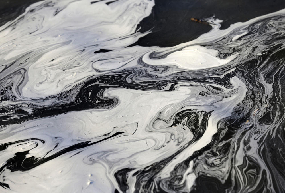 Coal ash swirls on the surface of the Dan River on Feb. 5, 2014 after <a href=