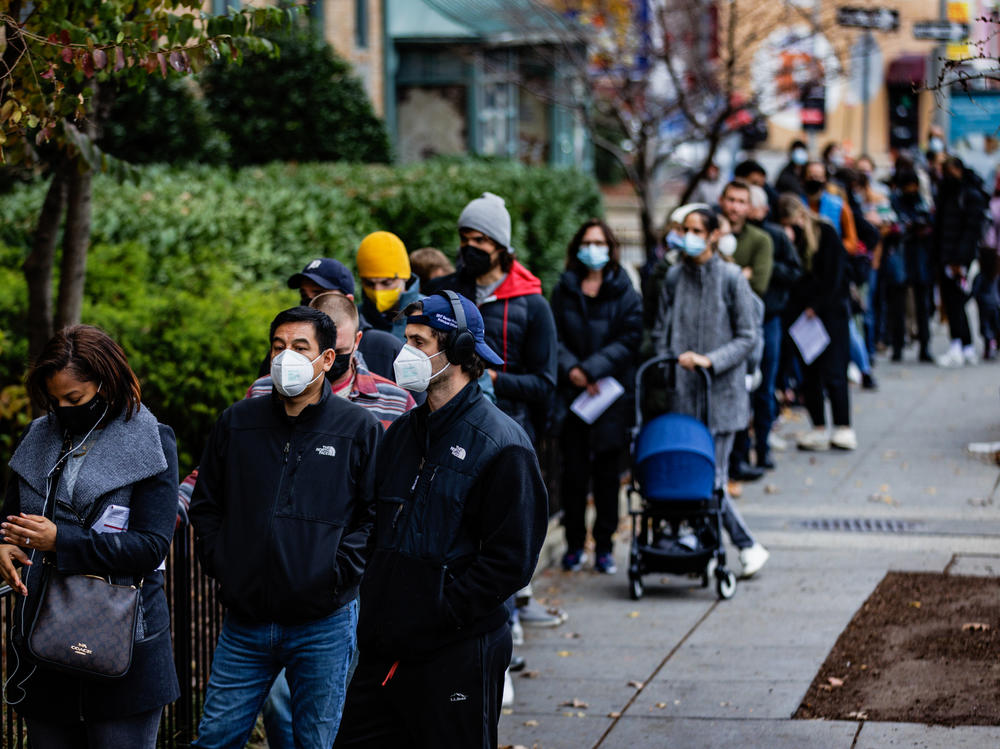 People line up outside a free COVID-19 vaccination site on Dec. 3 in Washington, D.C. Many areas are stepping up vaccination and booster shots as more cases of the omicron variant of the coronavirus are detected in the United States.