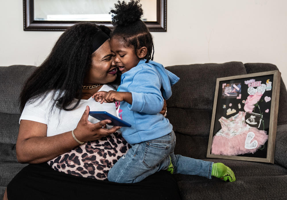 Lakisha Lowe spends time at home in Washington, D.C., with her son, Channing Jr., and framed items of Miamor, her daughter who died three weeks before Lakisha's due date in 2018. D.C. mothers of all races experience higher rates of infant mortality than the national average. <a href=