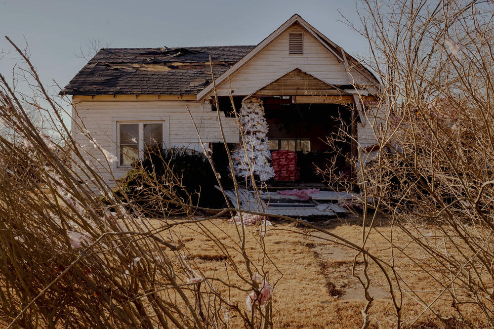 A Christmas tree stands in a home that was severely damaged in Defiance, Mo., on Dec. 13. A tornado ripped through the community of roughly 150 on Dec. 10, killing one and several damaging over a dozen homes. <a href=