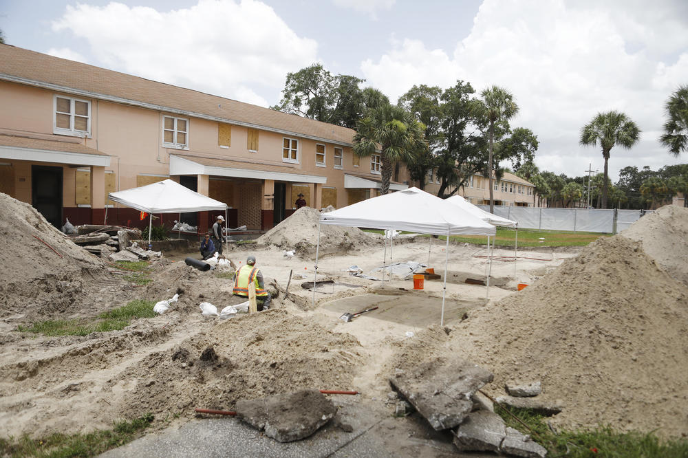 Archaeologists work to uncover graves at the former site of the Zion cemetery found underneath the Robles Park Village housing complex in Tampa, Fla. Another unmarked African-American cemetery with hundreds of graves has been found at the site of a downtown office building in Clearwater, Fla.