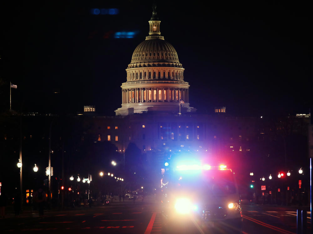 A police car drives away from the U.S. Capitol on Jan. 6, 2021.