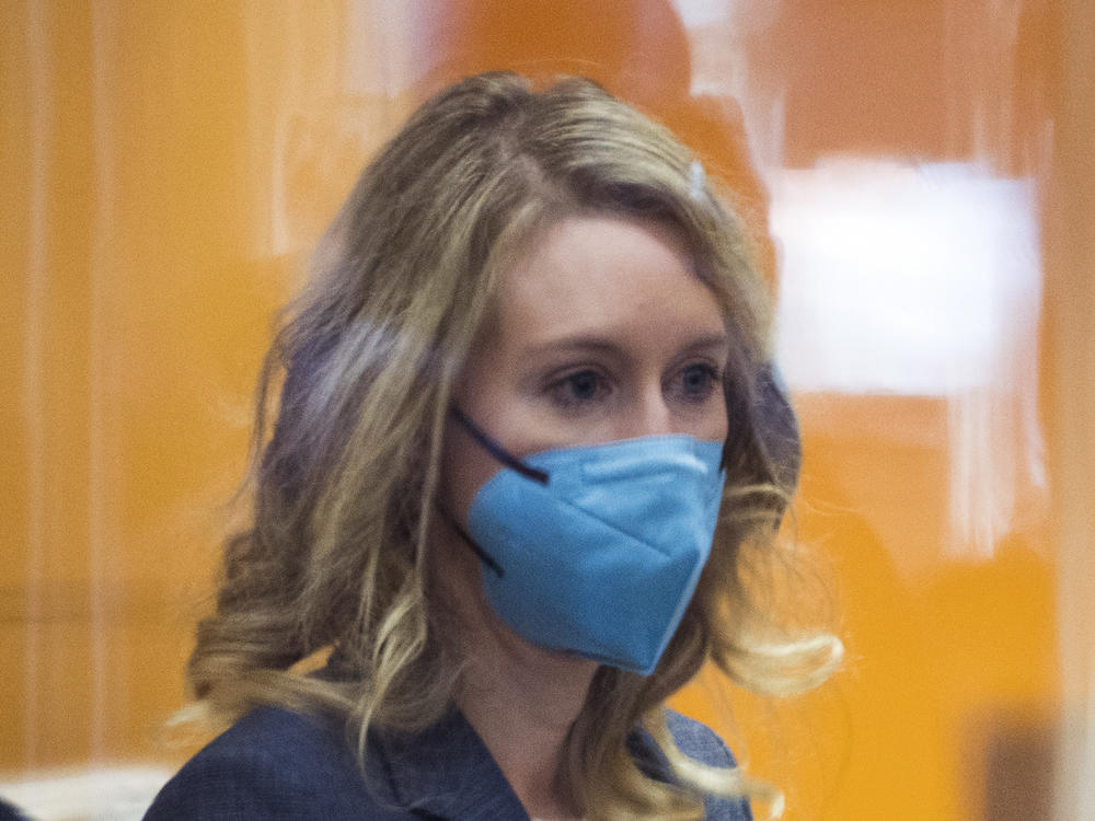 Elizabeth Holmes walks into federal court in San Jose, Calif., Friday, Dec. 17, 2021.