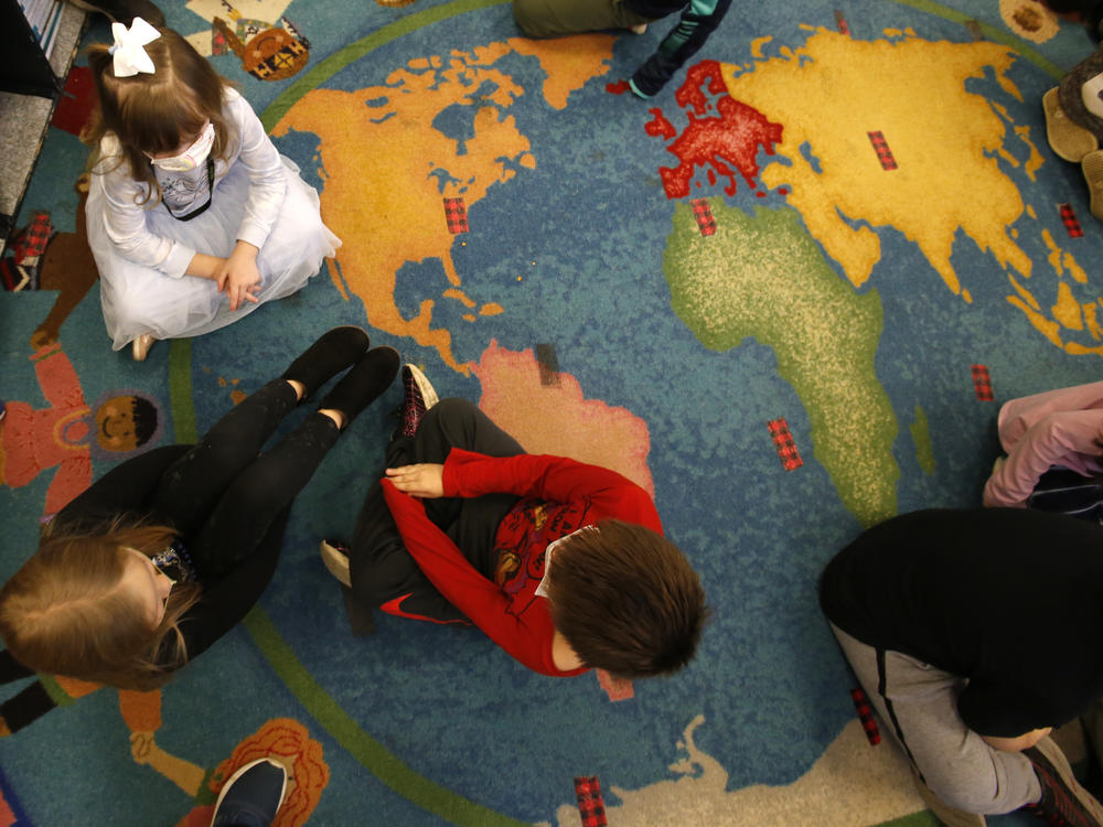 Second-graders talk in small groups about their how they're feeling at Paw Paw Elementary School in Paw Paw, Mich. With an infusion of federal COVID relief money and state funding this year, every child in this district's 11 schools is receiving extra support of some kind.