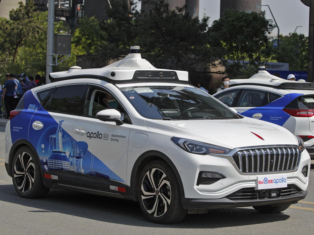 Baidu Apollo Robotaxis move on a street in Beijing on May 2. Chinese tech giant Baidu rolled out its paid driverless taxi service, making it the first company that commercialized autonomous driving operations in China.