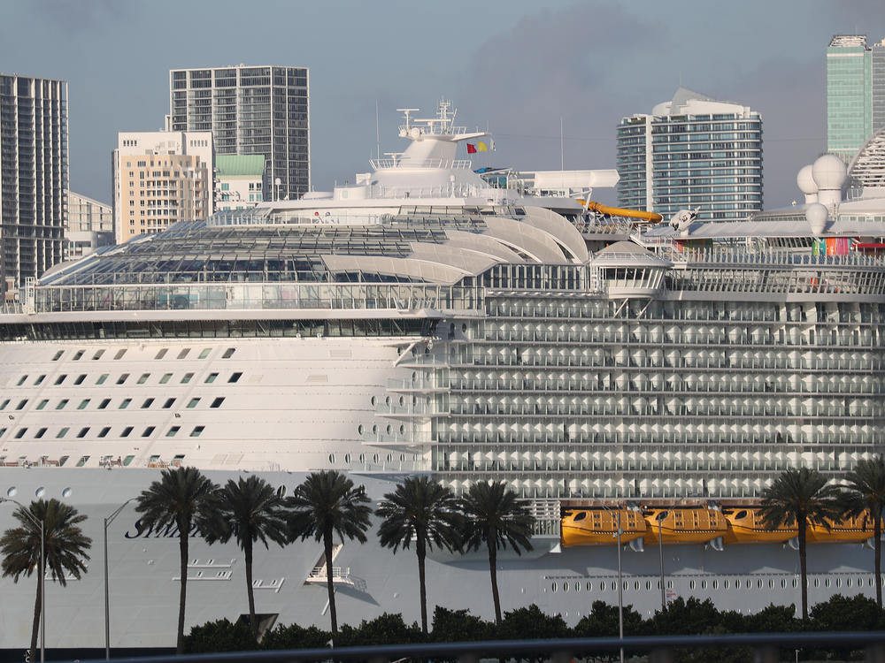 Royal Caribbean's <em>Symphony of the Seas</em> cruise ship, seen docked in Miami in March 2020, saw 48 cases of COVID-19 on its most recent seven-day sailing.