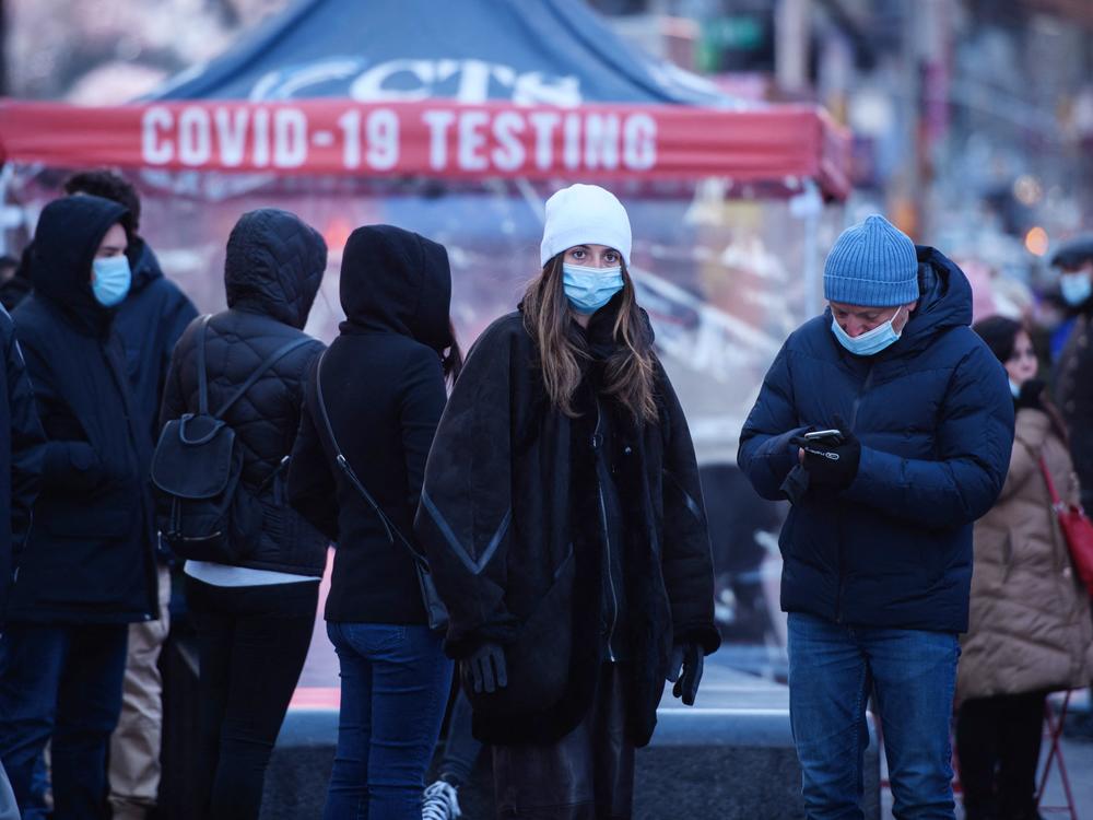 People wait at a street-side testing booth in New York's Times Square on Monday.